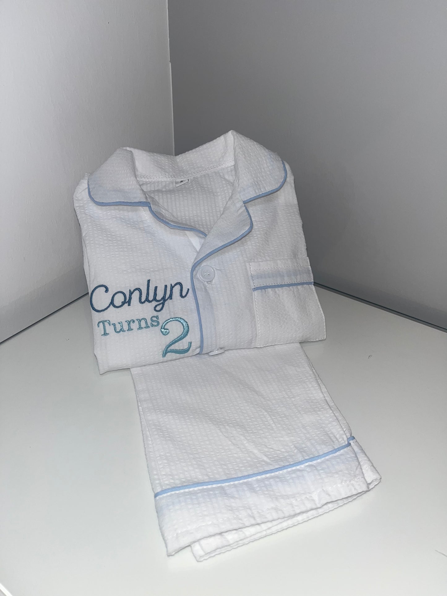 Boys White Suckseeker PJs with Pale Blue Lining Detail